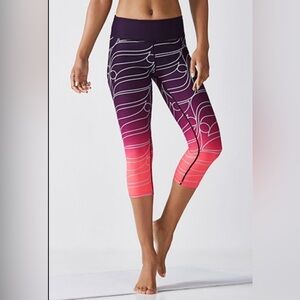 Women’s Fabletics Define PowerHold® Mid-Rise Capri. Pop Coral Reflective Ombre.